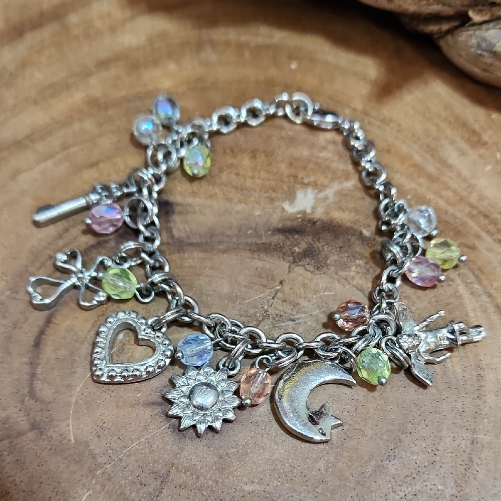 Silver Toned Charm Bracelet with a Key, Angel, Cross, Heart, Sun, Moon And Star
